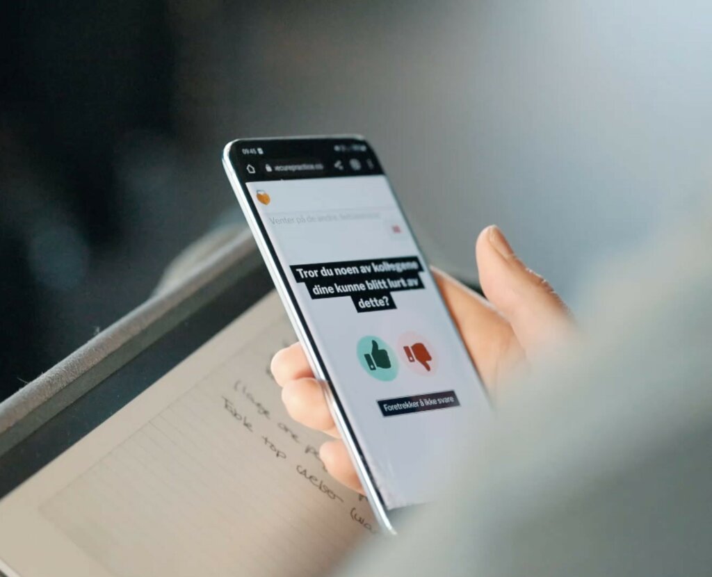 A participant using their phone to engage in the live cybersecurity exercise.